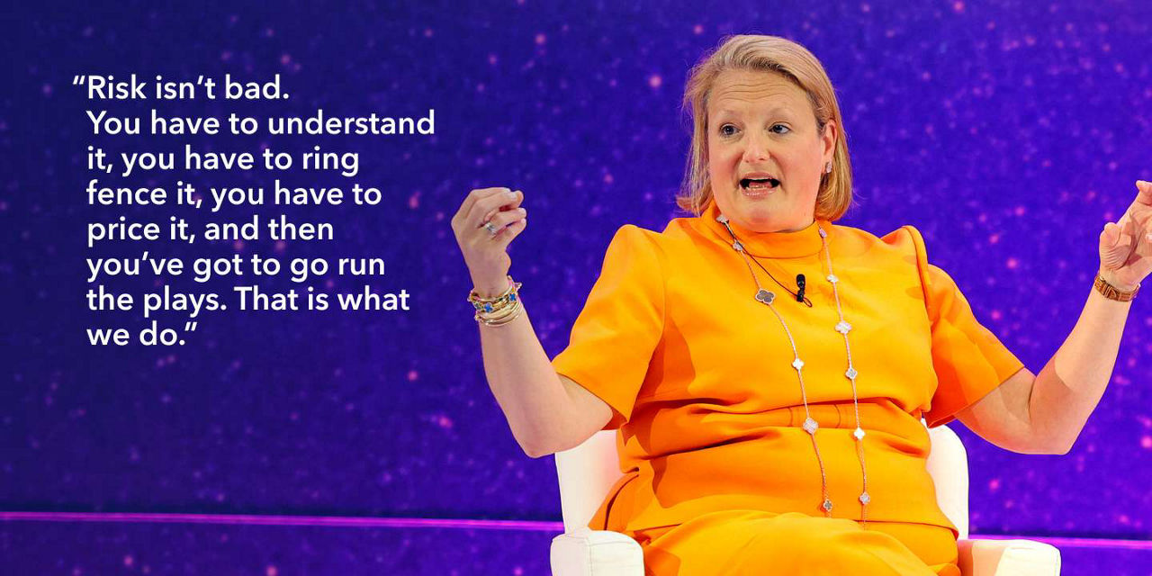 Alisa Amarosa Wood, Partner, Private Equity, KKR, seated and gesturing with hands. "Risk isn’t bad. You have to understand it, you have to ring fence it, you have to price it, and then you’ve got to go run the plays. That is what we do."