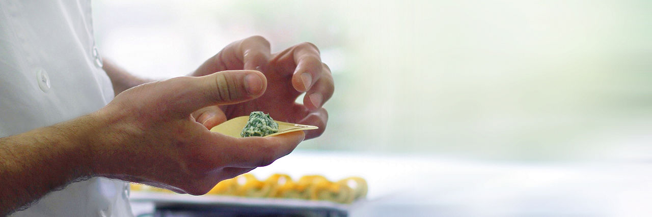 Chef folding dumplings